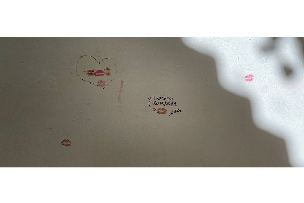 Lipstick kisses on white wall