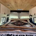 Down quilt on bed in van