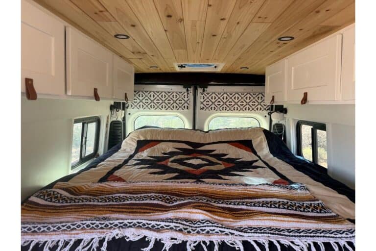 Down quilt on bed in van