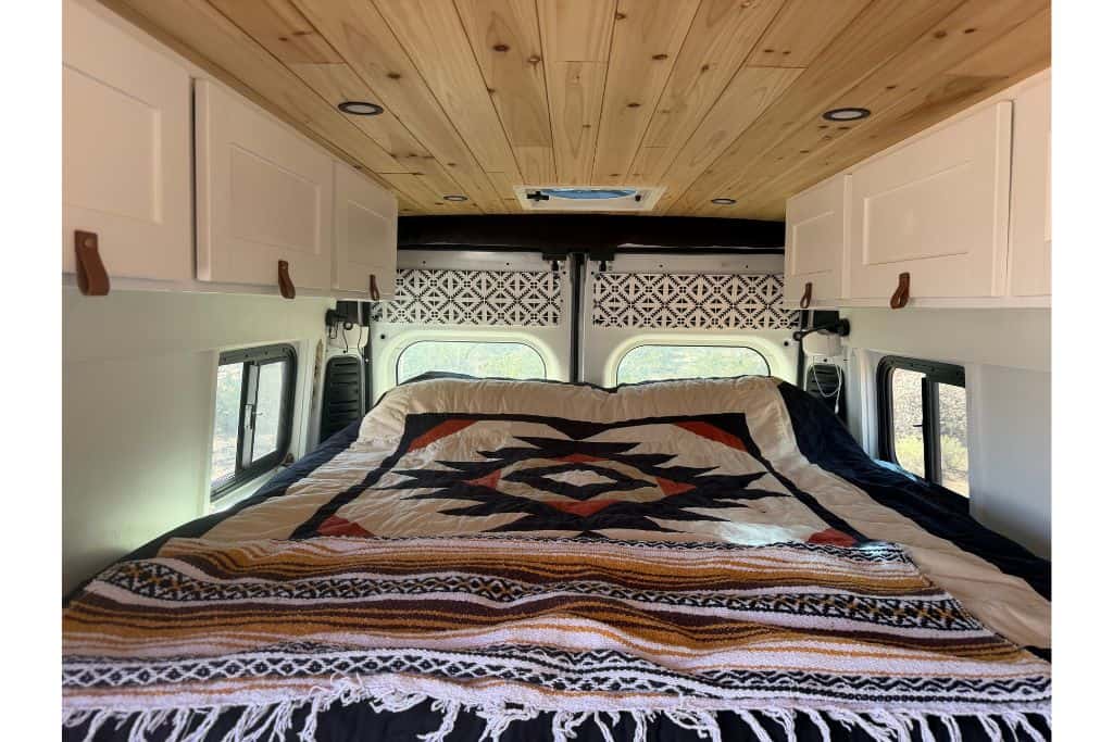 Down quilt on bed in van