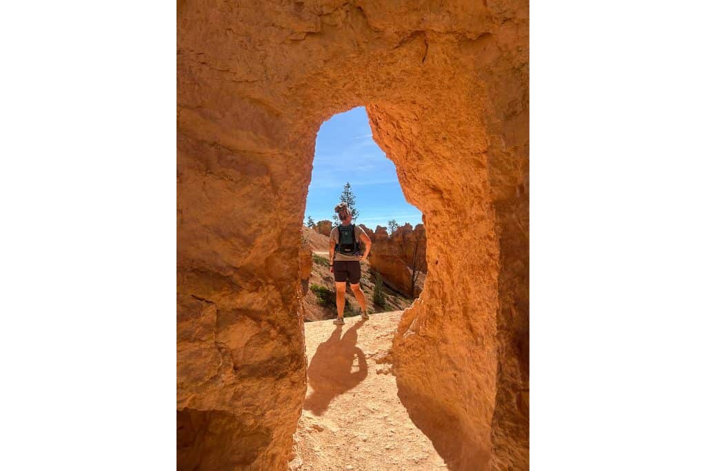 Hiker standing in tunnel, Bryce Canyon