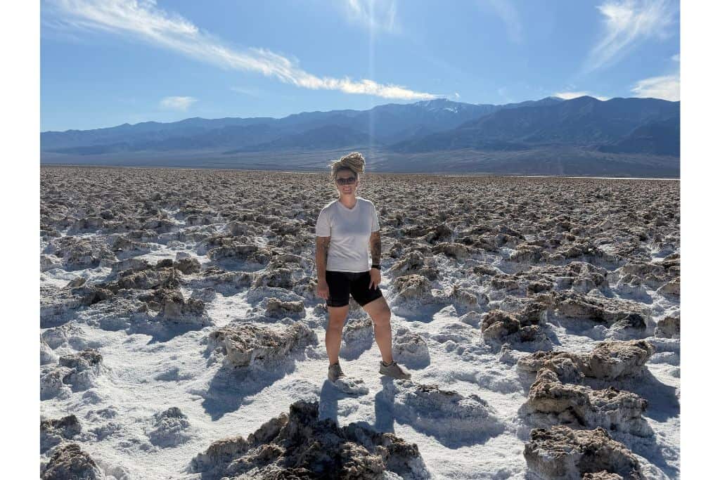 Woman standing in salt pan in death valley
