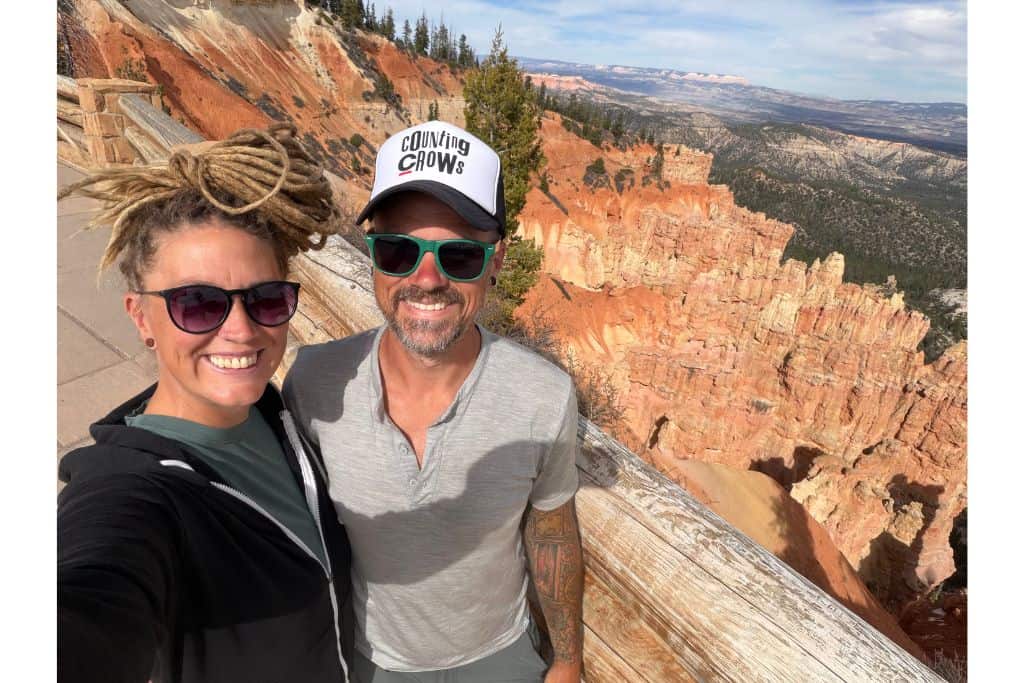 couple standing in front of sandstone hoodoos in Bryce Canyon