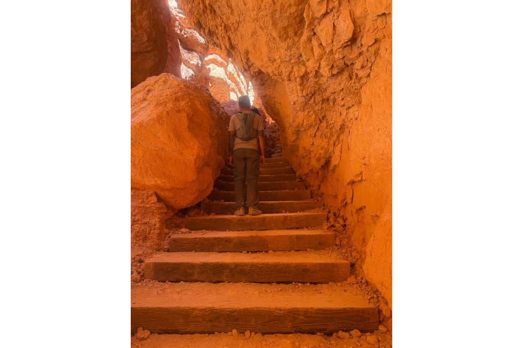 Hiker on stone steps in Bryce Canyon's Wall Stree