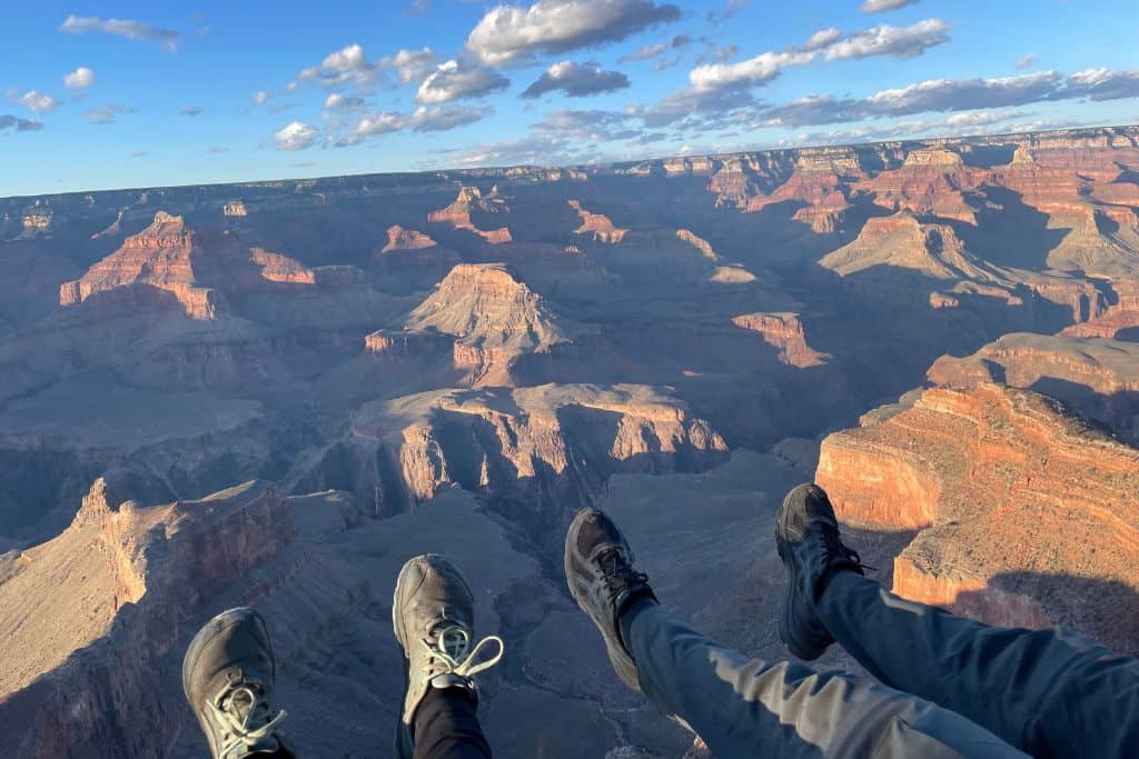 Feet dangling from the rim of the Grand Canyon