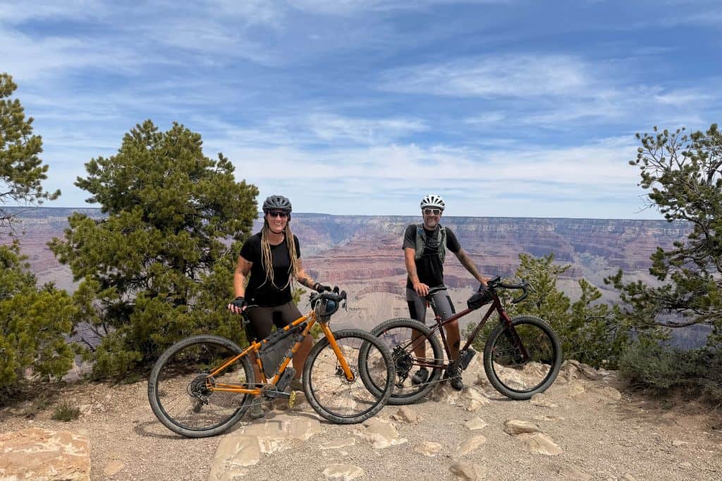 Man and woman with bicycles on rim of Grand Canyon