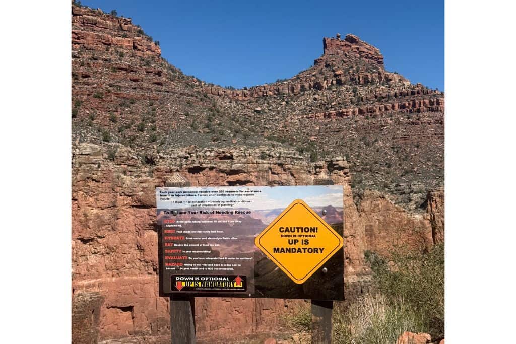 Sign warning that hiking down is optional, up is mandatory, Grand Canyon