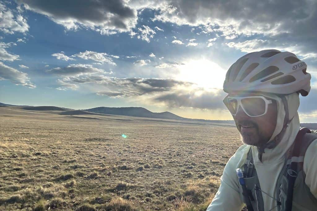 Bicycle rider with sun in the clouds 