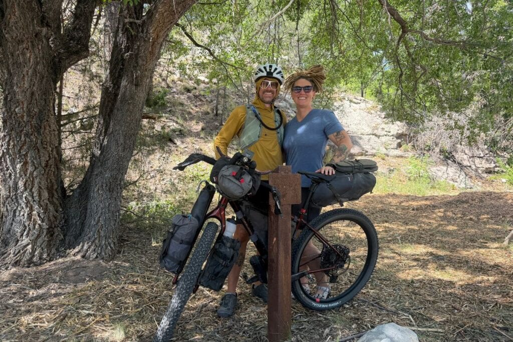 Couple standing with loaded bikepacking rig