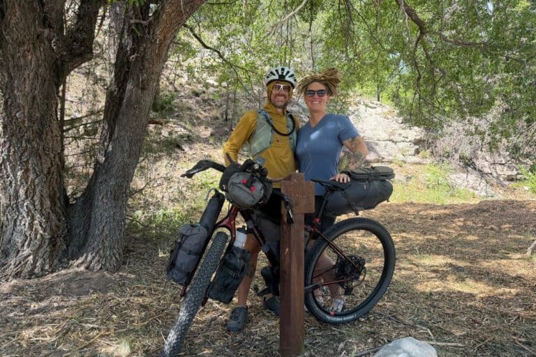 Couple standing with loaded bikepacking rig