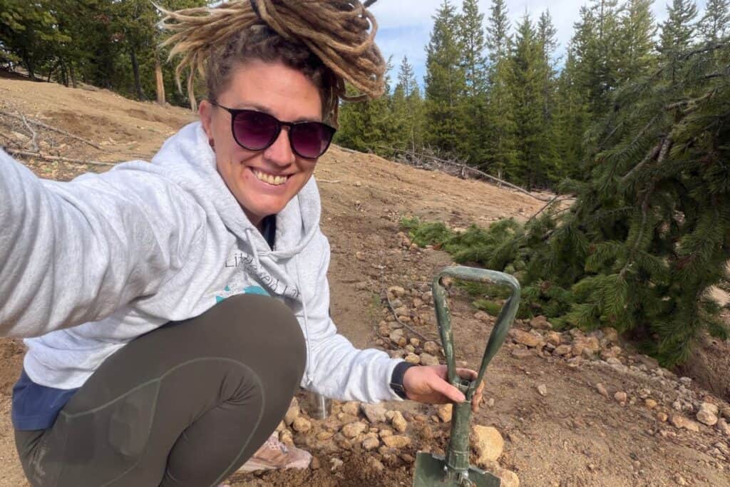 Woman with camp shovel digging for crystals