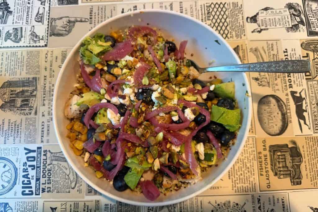 Colorful bowl of food on newsprint table top