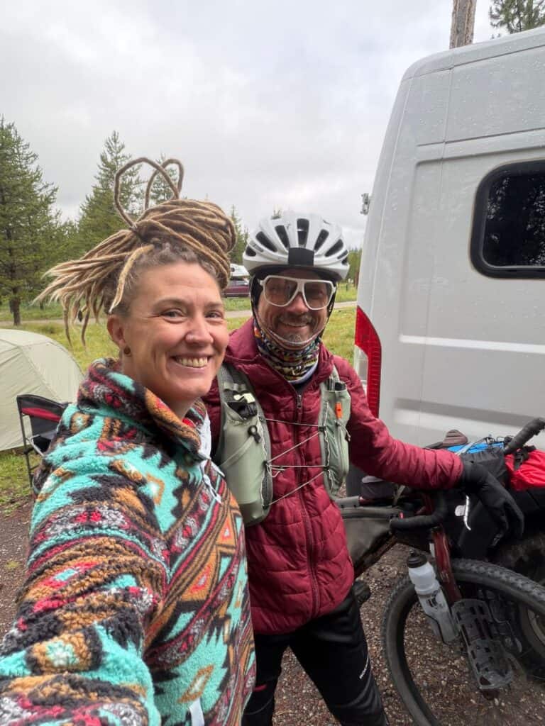 Couple in camp, dressed for endurance bike ride