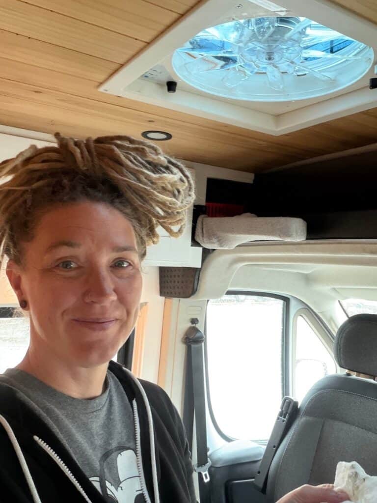 Woman cleaning camper van vent 